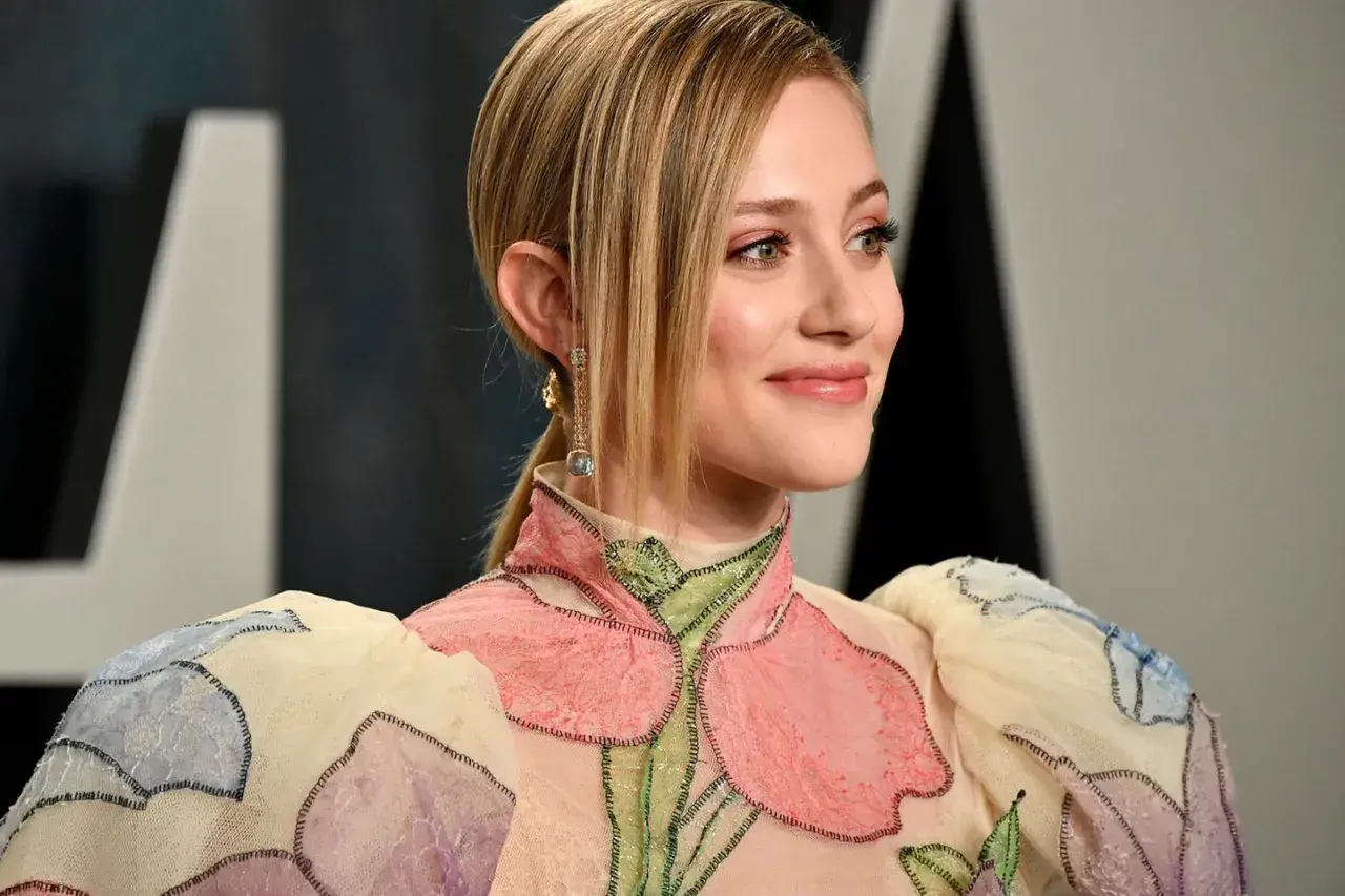 Ein Lächeln in Pfirsich-Nude-Tönen, das durch ein blumenverziertes Kleid und funkelnde Ohrringe unterstrichen wird.